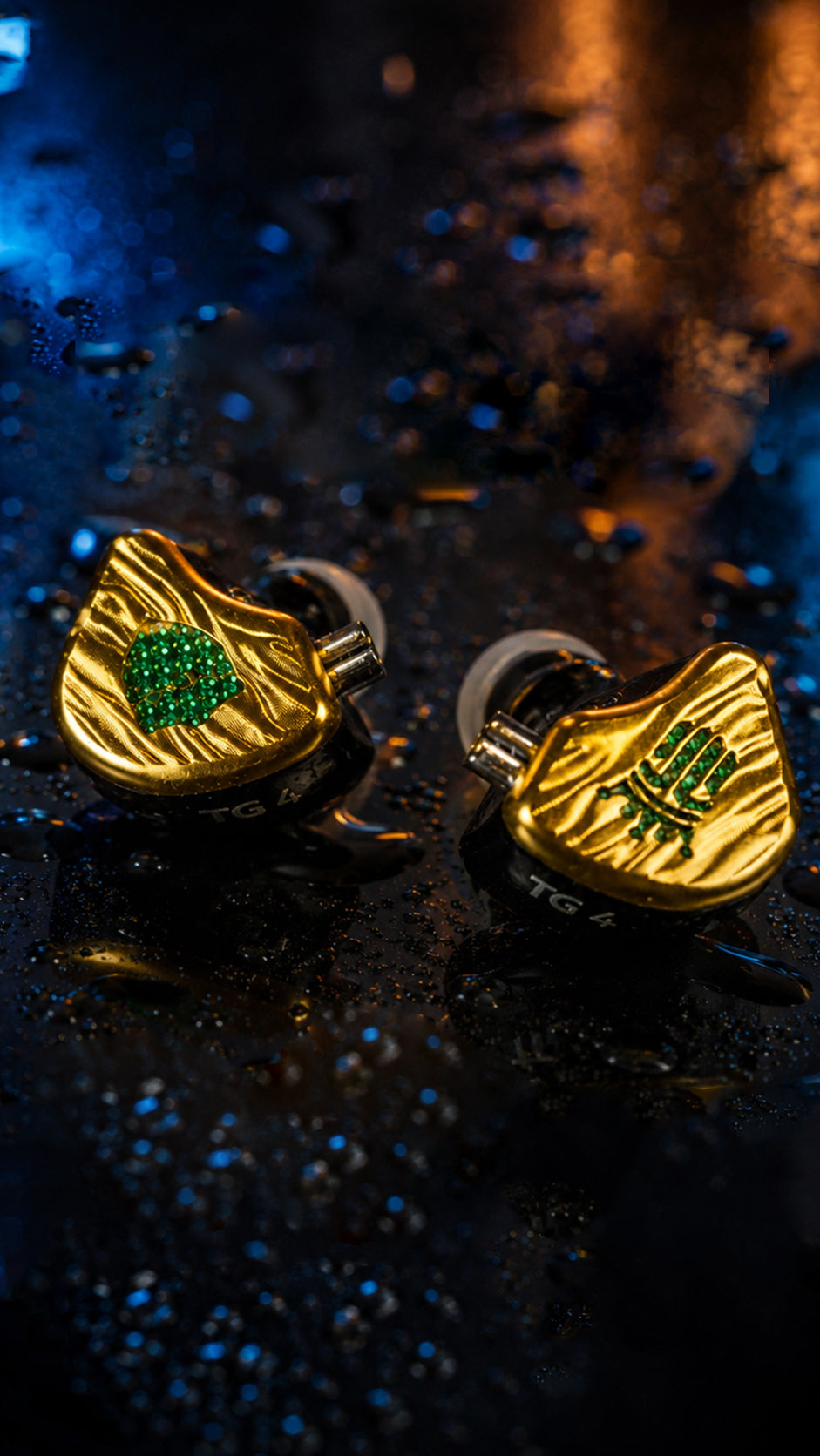 Tipsy TG4 gold and black in-ear monitors on a wet reflective surface