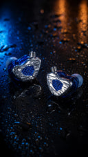 Tipsy TG4 silver and blue in-ear monitors on a wet reflective surface